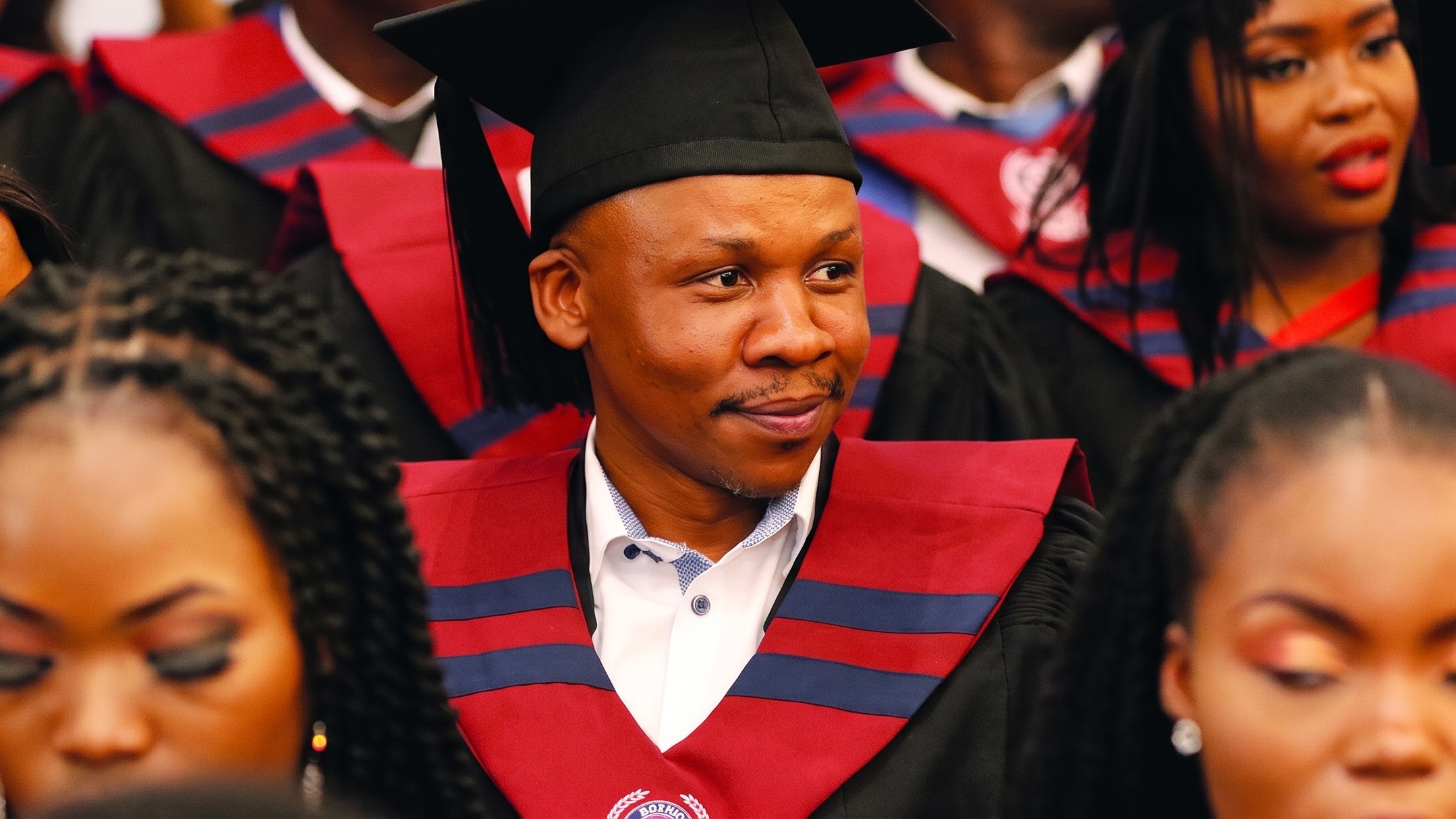 An alumnus in graduation robes